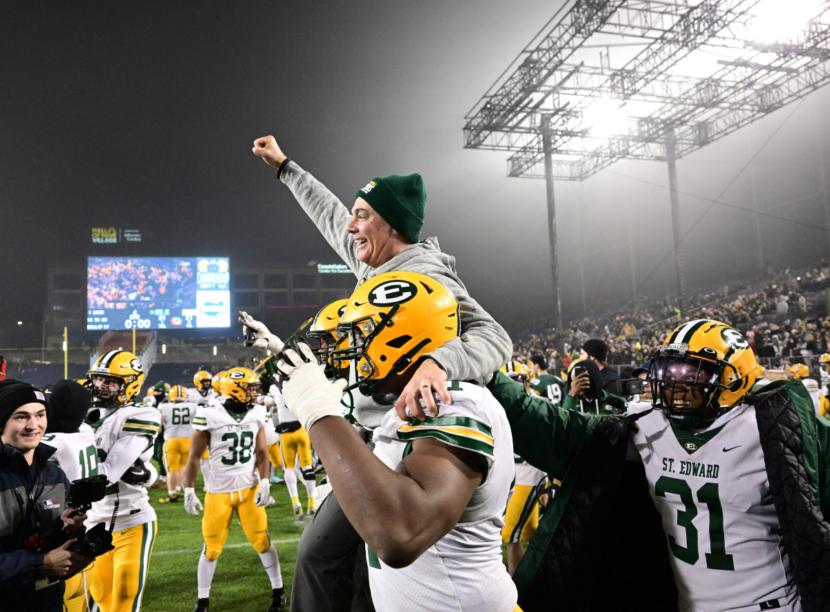 St. Edward head coach Tom Lombardo is carried off by his players after winning the Division I state title on December 1, 2023. Photo credit: Jeff Harwell, SBLive Sports